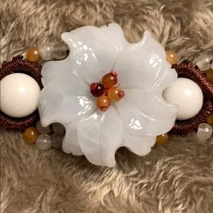 Brown braided bracelet with jade flower
